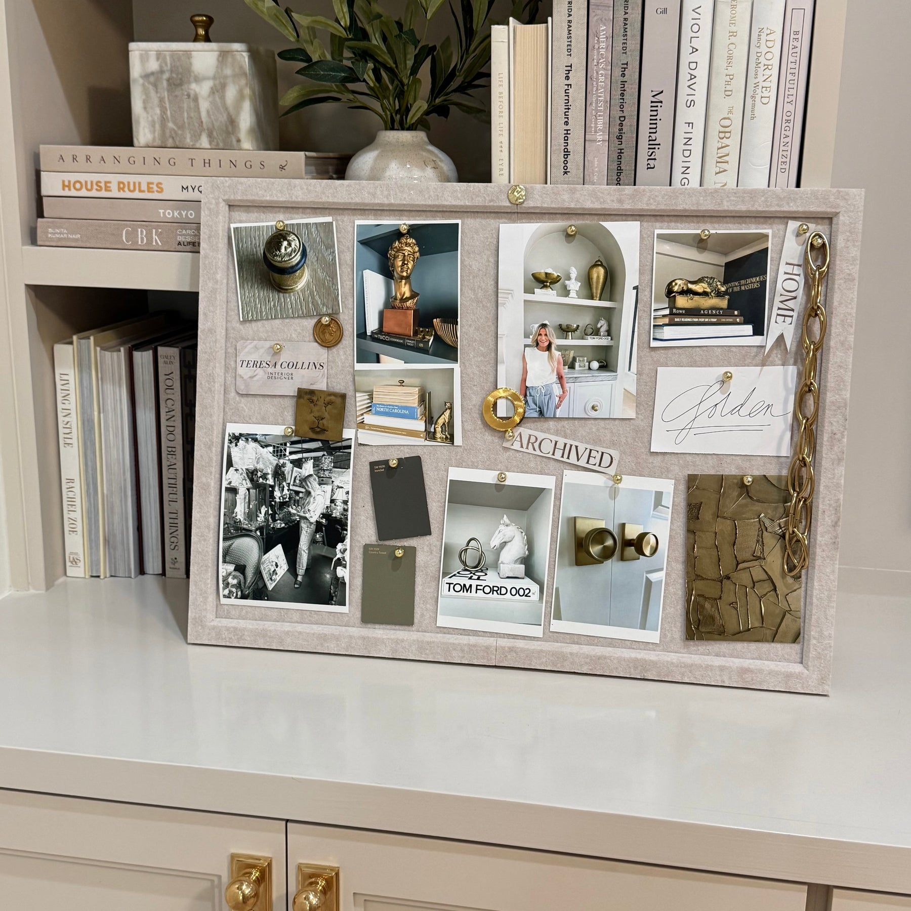 Beige felt pinboard styled with photographs, finishes and design references